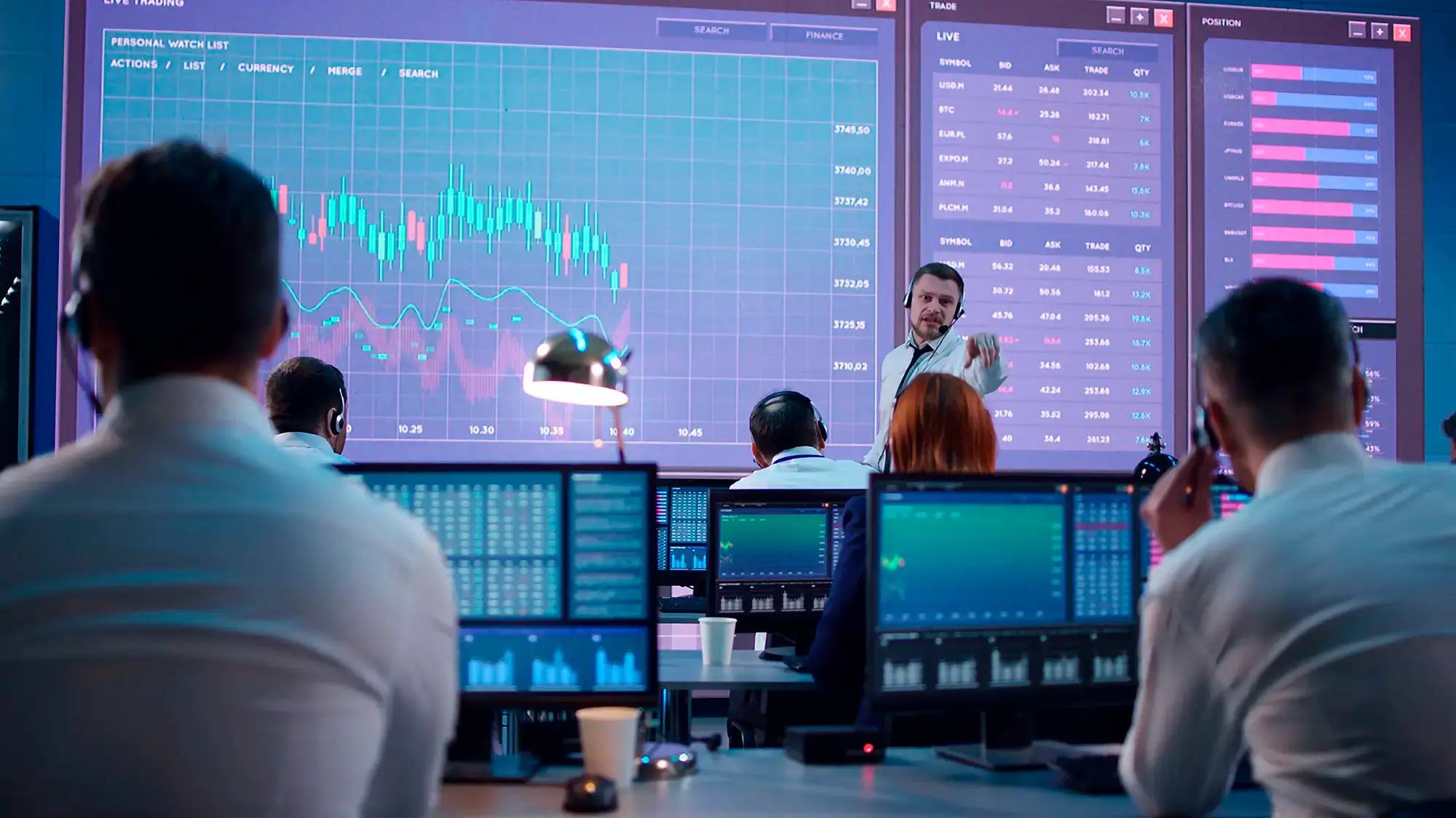 Stock image of business analysts looking at digital chart